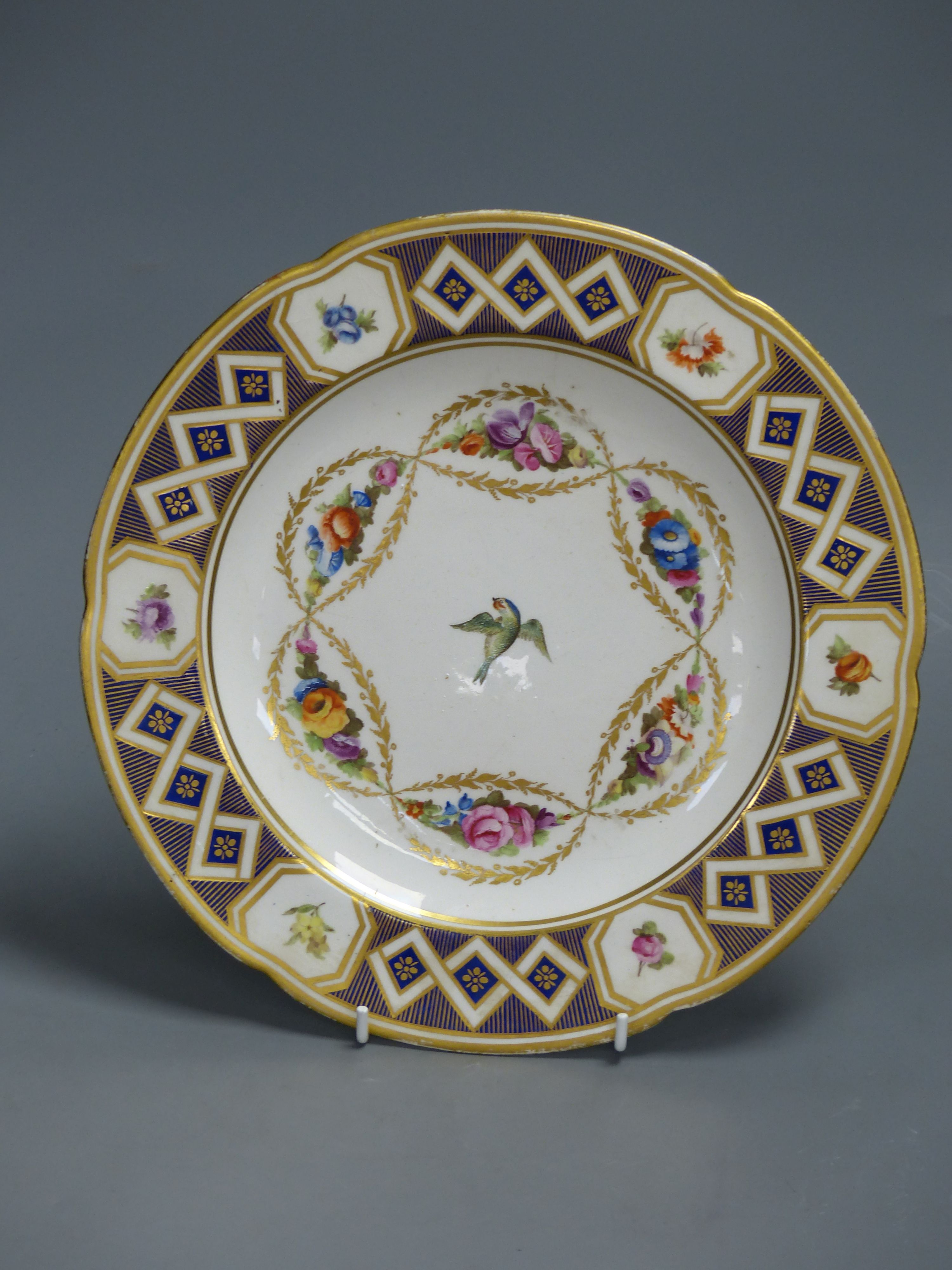 A Derby plate painted with central bird and leafy chains, c.1800, diameter 26.5cm